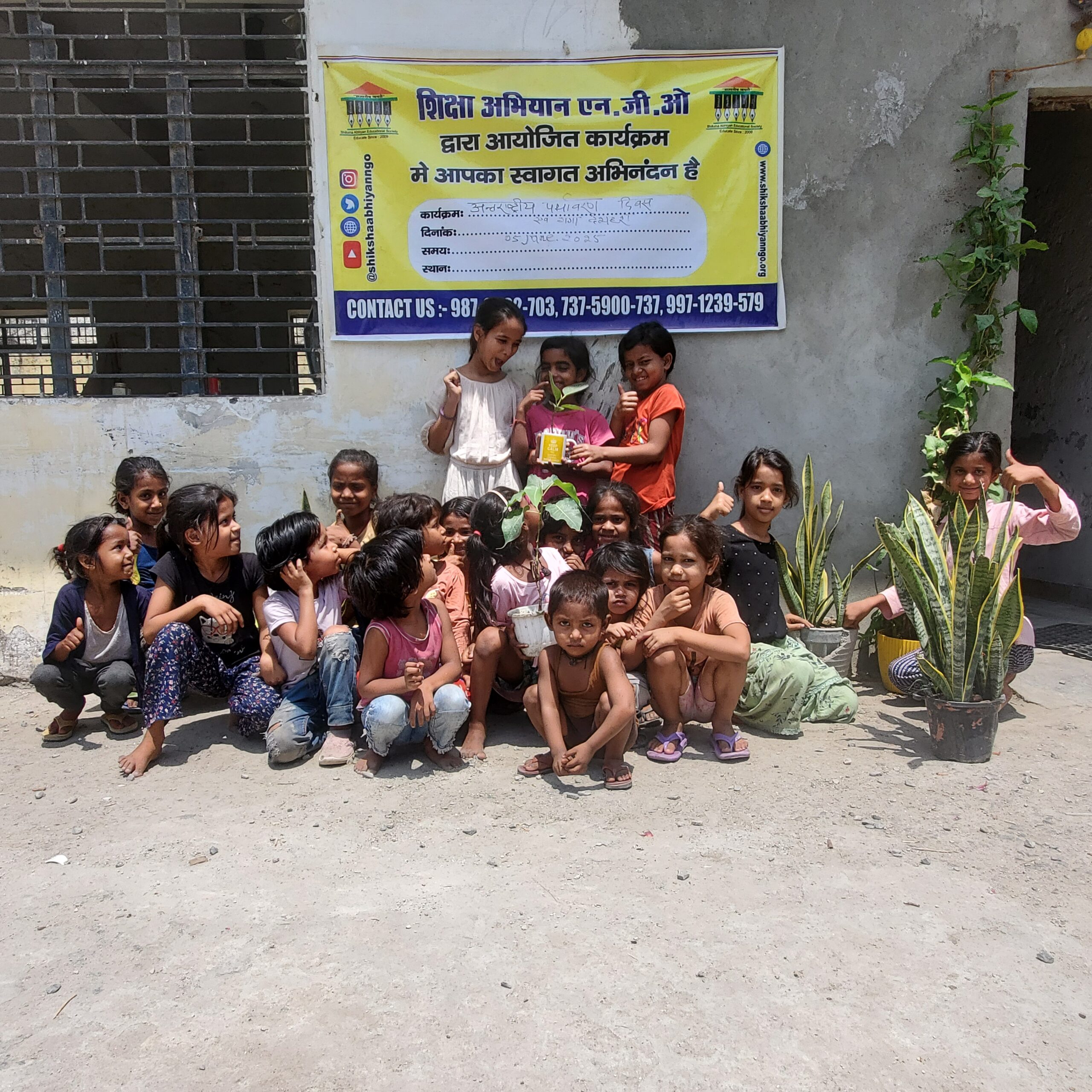 Hands planting a sapling in soil